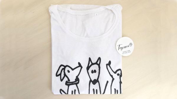t-shirt trio cagnolini realizzata in cotone con stampa sublimatica disegno di marco ferrari per Toscani store piegata su tavolo legno